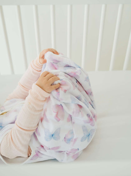Baby cozy in Butterfly Wearable Minky Blanket, featuring a soft butterfly design for safe sleep and comfort.