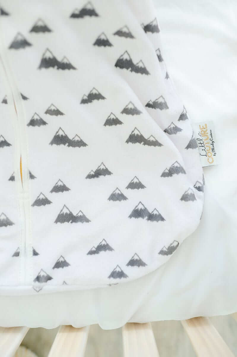 Mountains Wearable Minky Blanket featuring small gray mountain prints on white fabric.