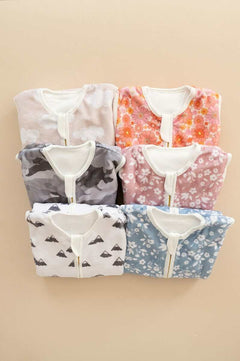 Wearable Minky Blankets in various designs including mountains and flowers, perfect for safe infant sleep.
