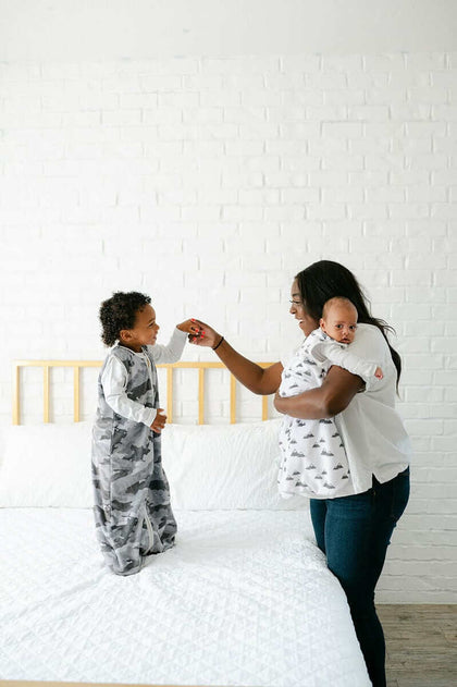 Mother and child in Camo Wearable Minky Blanket, promoting safe sleep alternatives for infants.