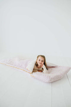 Pink Check Sleeping Bag with a girl smiling inside the cozy Minky Couture sleeping bag.