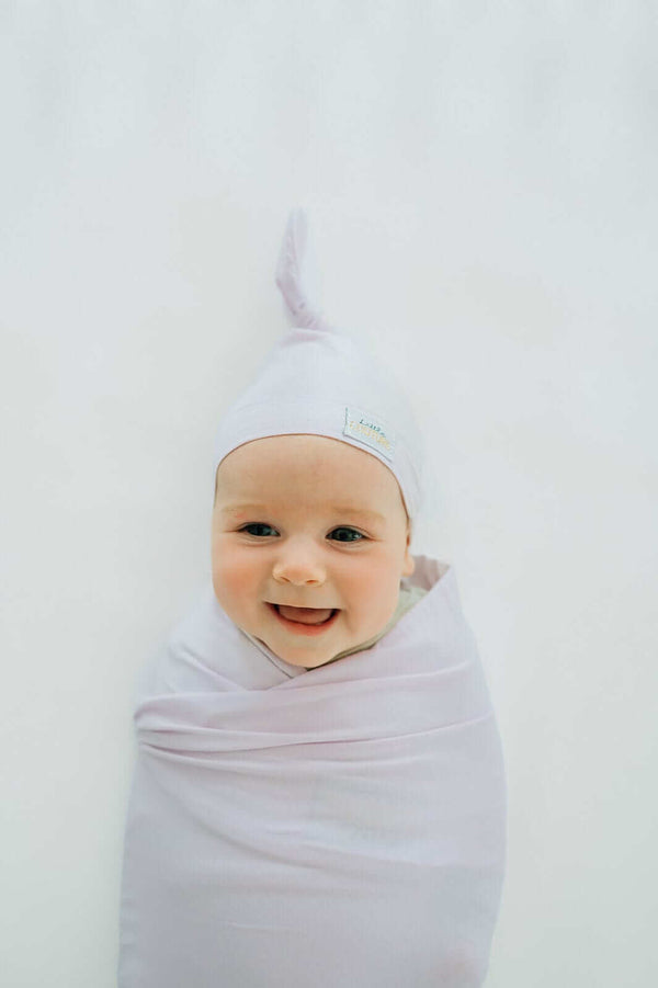 Minky Couture Lavender Swaddle and Hat combo with a happy baby wrapped in.