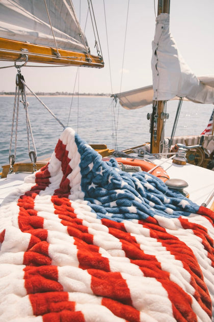 Close-up of a blanket with red, white, and blue American flag.