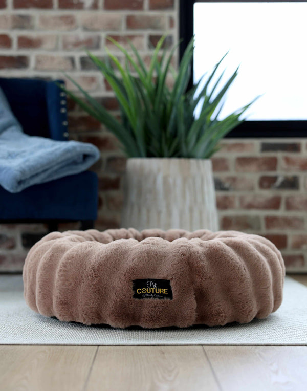 Minky Couture Milk Chocolate Pet Bed cover on a cozy floor with a plant in the background, showcasing its plush texture.