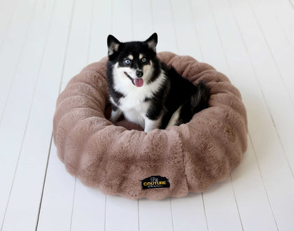 Minky Couture Milk Chocolate Pet Bed cover on a plush dog bed with a happy dog sitting on it.