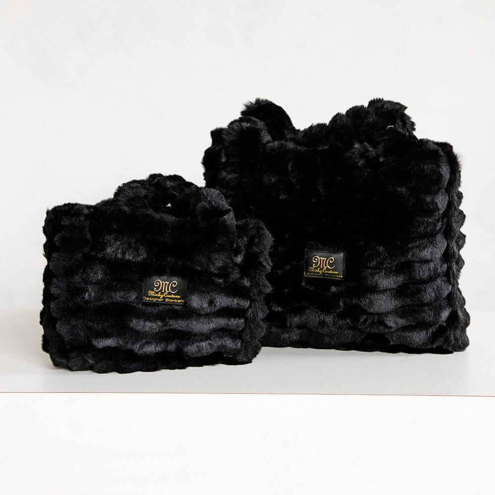 Two black Minky Couture Annie bags in different sizes displayed side by side against a white background.