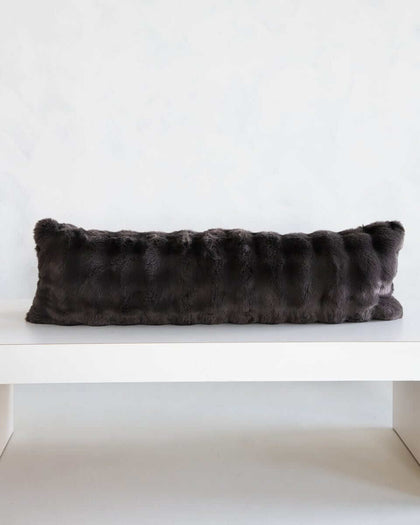 Charcoal Cloud Sham on a white shelf, showcasing its plush fabric and modern design.