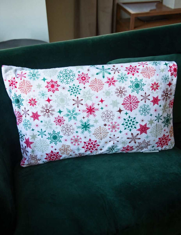 Snowflake 2025 | Christmas Pillowcase featuring festive snowflakes in red and green on a white background.