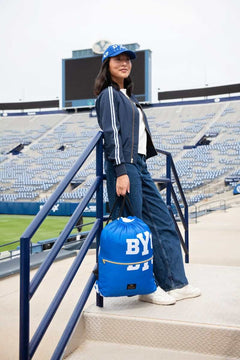 BYU Cougars Hooded Stadium Blanket displayed by a fashionable model in a stadium setting.