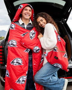 Couple wrapped in Minky Couture red Southern Utah University Thunderbirds blankets at a tailgate.