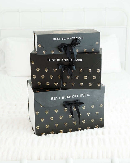 Large Gift Box showcasing three beautifully packaged items with luxurious design and elegant ribbons.