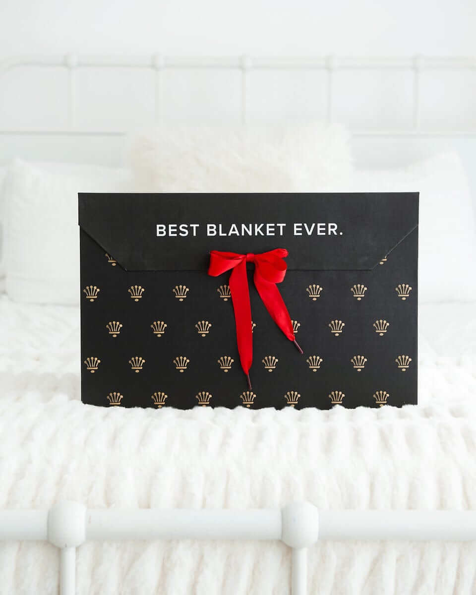 Gift Box with red ribbon featuring the text 'BEST BLANKET EVER' on a luxurious black background.