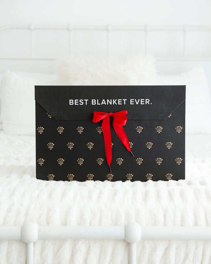 Gift Box with red ribbon featuring the text 'BEST BLANKET EVER' on a luxurious black background.