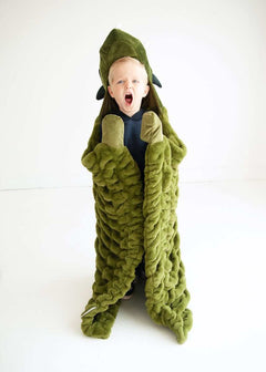 Child wrapped in Minky Couture Huggable Dino green blanket, excitedly embodying a playful dinosaur.