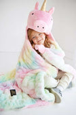 Child snuggled in Huggable Unicorn blanket with unicorn head hood and colorful pastel design.