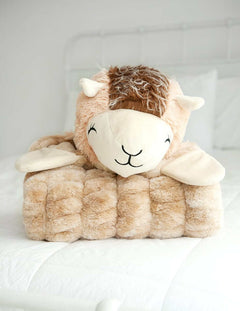 Huggable Llama plush head resting on a cozy tan blanket, perfect for cuddle time with your little one.