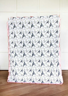 I Love Paris Blanket with Eiffel Tower pattern on a wooden floor.
