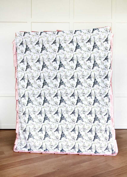 I Love Paris Blanket with Eiffel Tower pattern on a wooden floor.