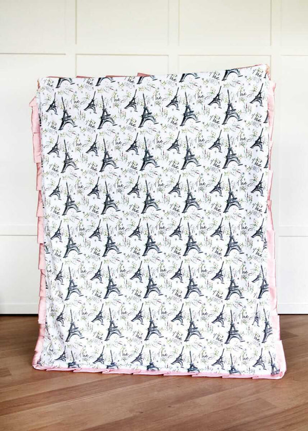 I Love Paris Blanket with Eiffel Tower pattern on a wooden floor.