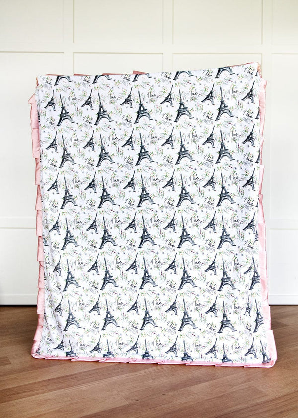 Blanket with Eiffel Tower pattern on a wooden floor