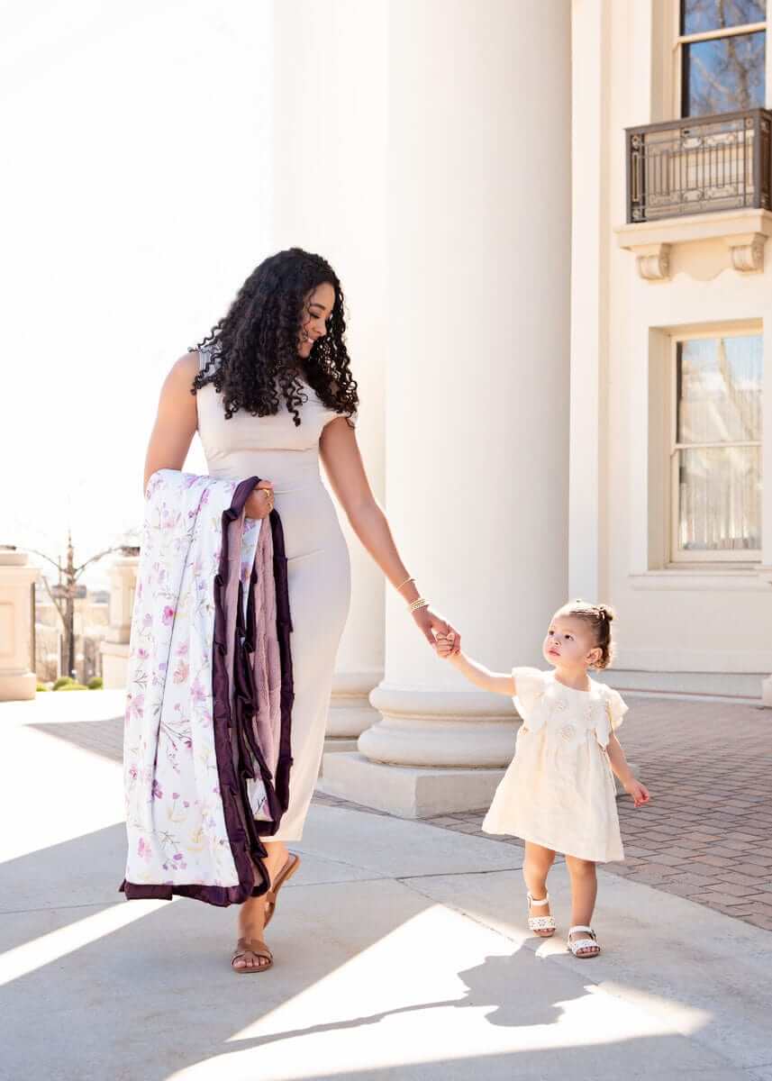 Mom and child enjoying outdoor stroll with the Dusty Plum Wildflower Blanket.