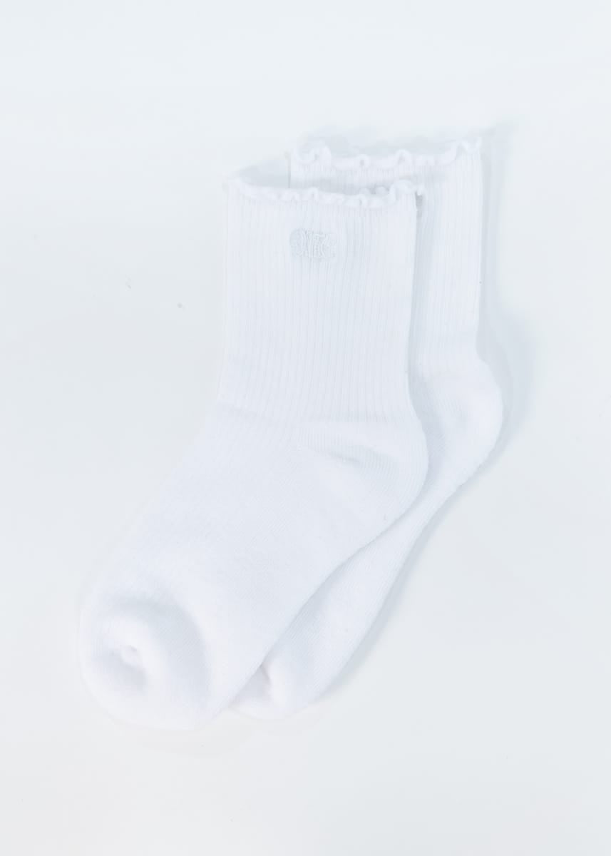 A pair of white ribbed crew socks with ruffled trim at the top, shown on a plain white background.