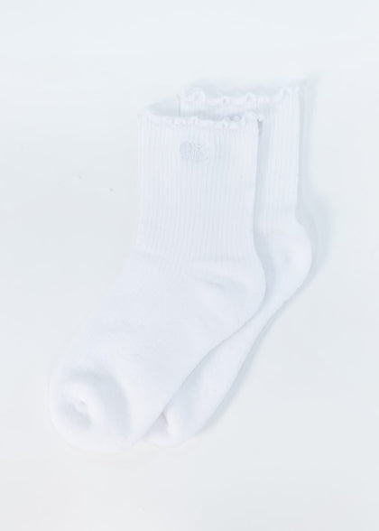 A pair of white ribbed crew socks with ruffled trim at the top, shown on a plain white background.
