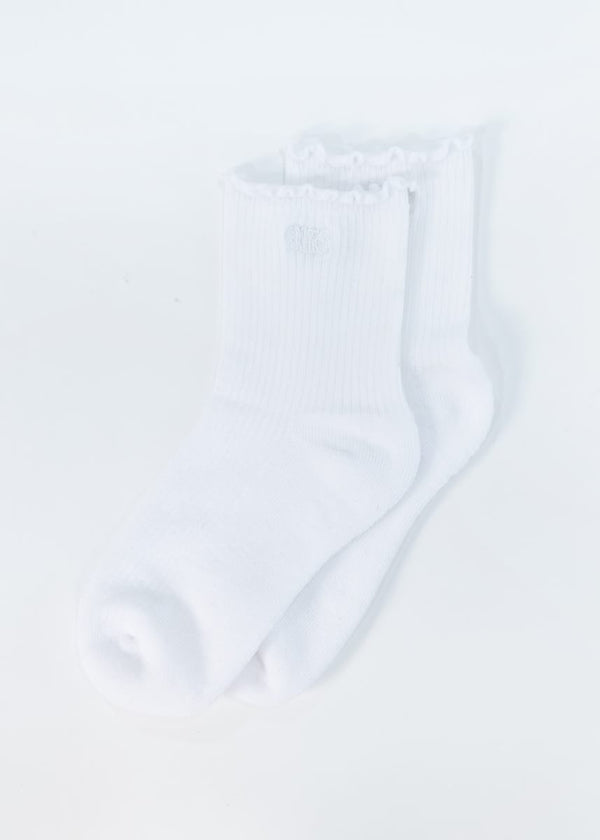 A pair of white ribbed crew socks with ruffled trim at the top, shown on a plain white background.
