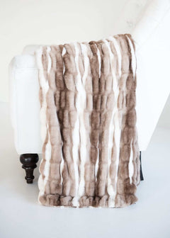 Cozy White Glove Hugs Swirl Hot Chocolate Minky Couture throw blanket draped over a white chair.