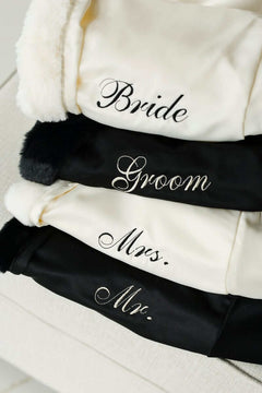 Minky Couture Robe collection showcasing Bride, Groom, Mrs., and Mr. embroidered robes stacked for a luxurious touch.