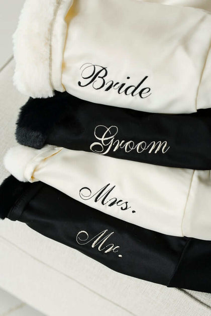 Minky Couture Robe collection showcasing Bride, Groom, Mrs., and Mr. embroidered robes stacked for a luxurious touch.