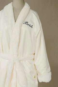 Satin Cream Robe featuring plush Minky lining, collar, pockets, and personalized "Bride" embroidery.