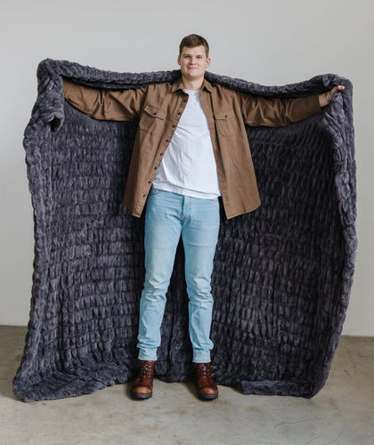 Walker Kessler holding a minky couture blanket