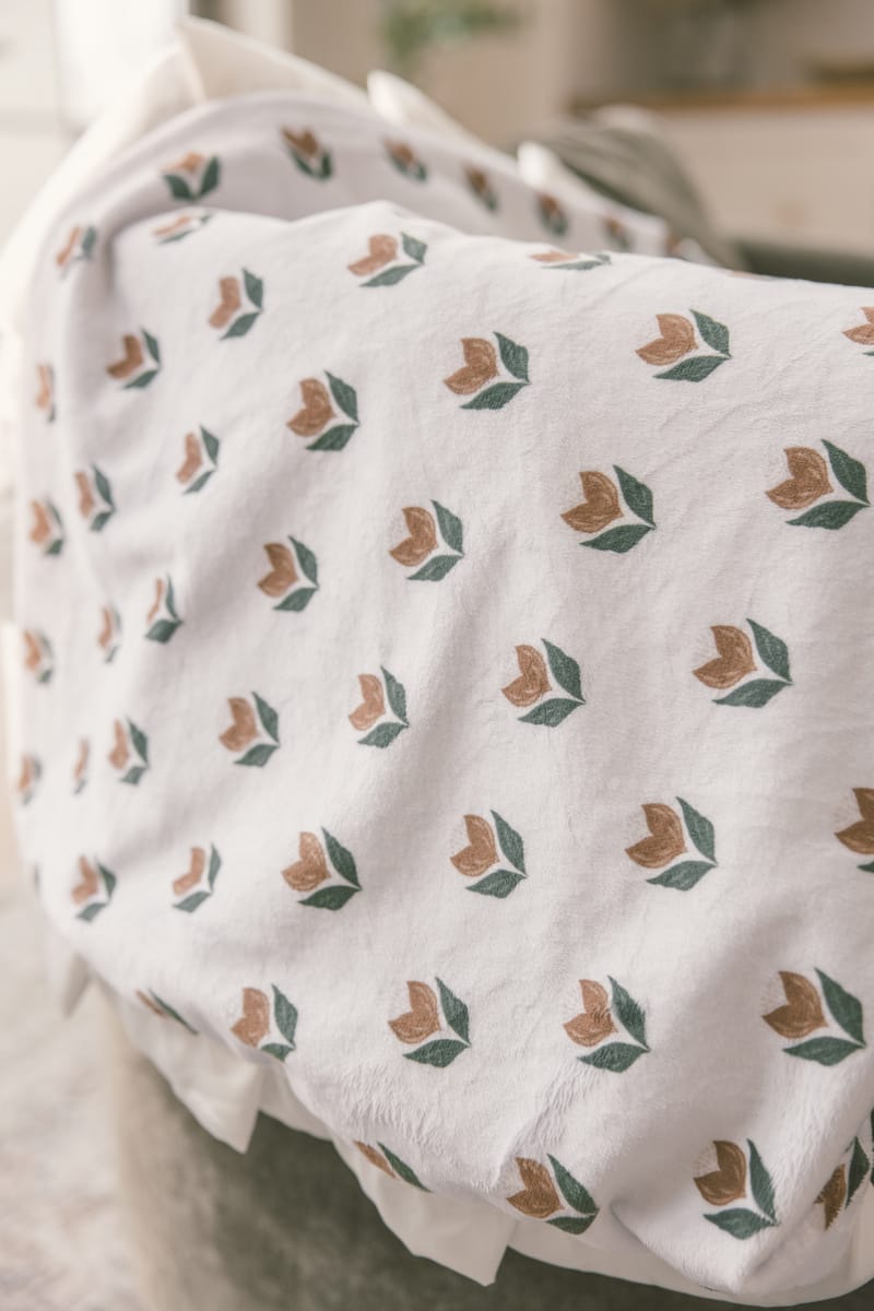 Floral patterned fabric draped over a chair with a blurred background