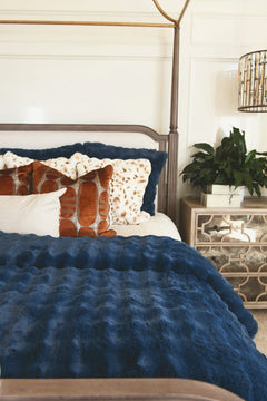 Navy Cloud Duvet on a bed with decorative pillows, showcasing its plush fabric and deep blue hue.
