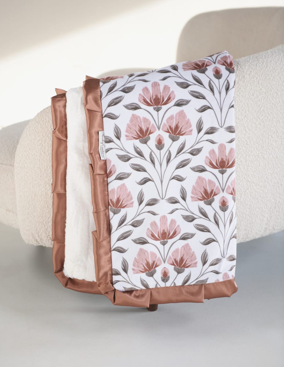 Flower Garden Blanket with floral print and plush backing, featuring peach blooms and bronze satin ruffle.