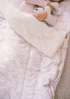 Sleeping Bag Pretty Pink Bows with plush Minky lining and zipper, featuring a child cuddling a toy.