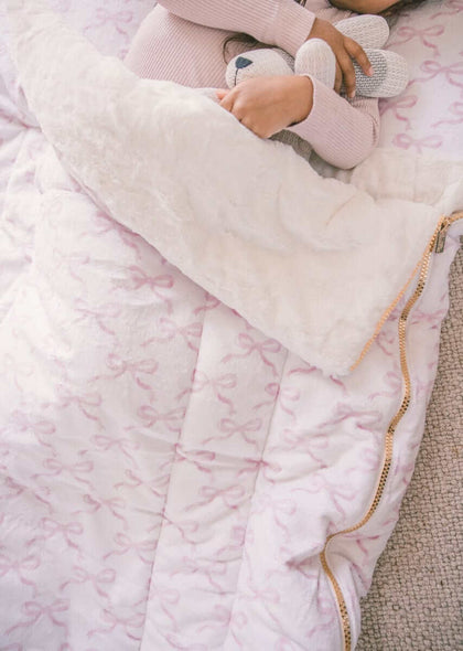 Sleeping Bag Pretty Pink Bows with plush Minky lining and zipper, featuring a child cuddling a toy.