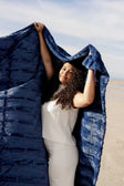 Woman holding the Sorbet Navy Blanket outdoors, showcasing its rich navy blue color and plush texture.