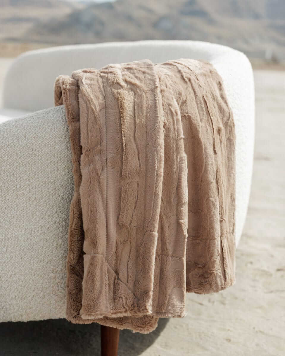 Sorbet Milk Chocolate Blanket draped over a couch, showcasing its rich, velvety texture and warm chocolatey hue.