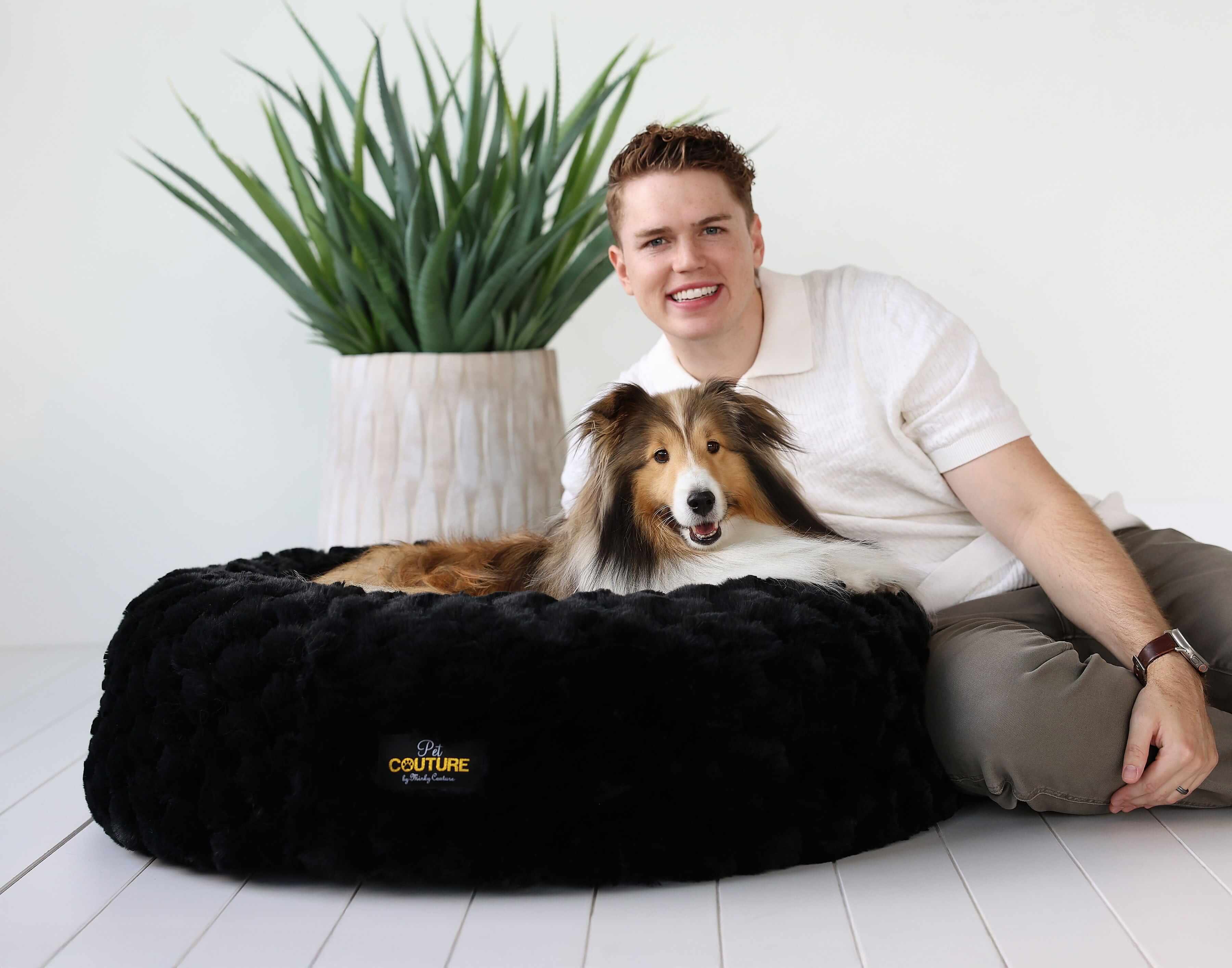 Minky Couture Black Crinkle Pet Bed with a happy dog and owner, showcasing comfort and style.