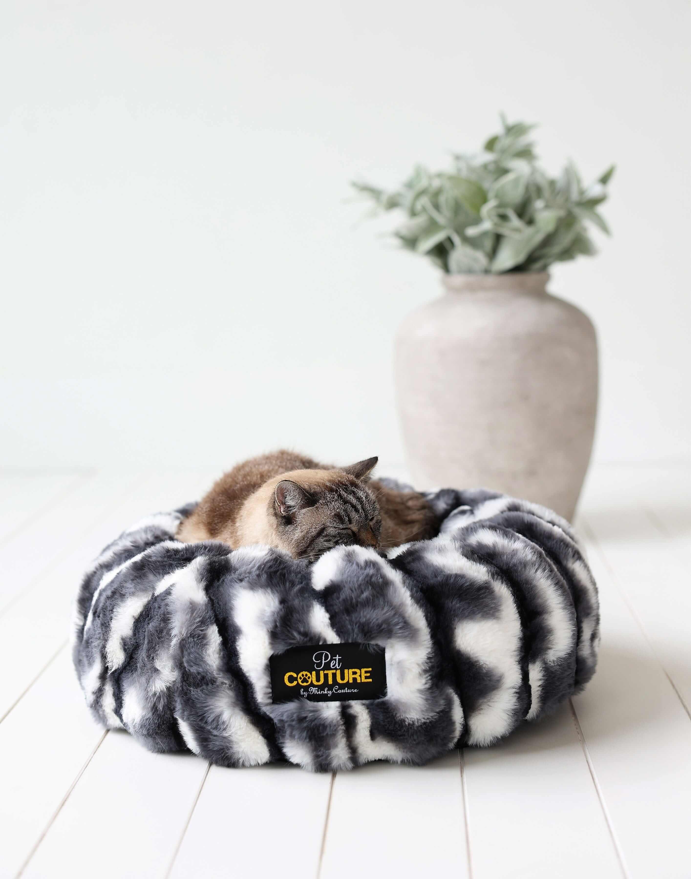 Cozy cat sleeping in a Minky Couture Cloudy Day Black Pet Bed made of soft fabric, surrounded by stylish decor.