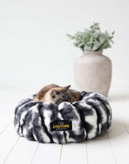 Cozy cat sleeping in a Minky Couture Cloudy Day Black Pet Bed made of soft fabric, surrounded by stylish decor.