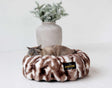 Minky Couture Cloudy Day Brown Pet Bed with a cat relaxing on a cozy, round shape designed for comfort and support.