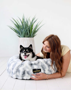 A person cuddling with a happy dog in a Cloudy Day Blue Pet Bed, showcasing comfort and style.