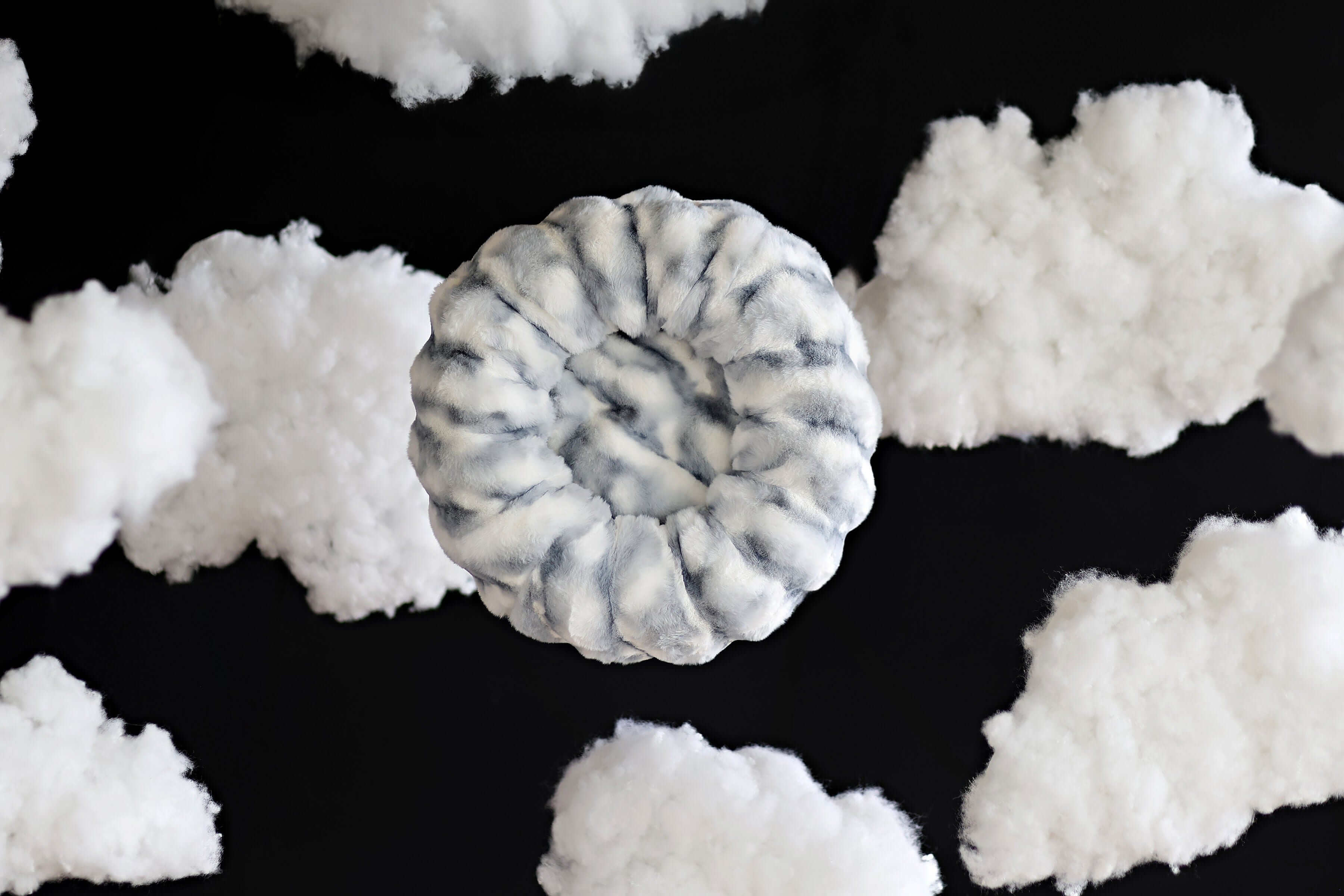 Cloudy Day Blue Pet Bed surrounded by fluffy clouds, offering cozy comfort and orthopedic support for pets.
