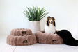 Various sizes Minky Couture Milk Chocolate Pet Beds featuring a furry dog lounging on the larger bed with black blanket.