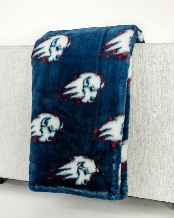Utah Tech Trailblazers logo plush blanket draped over light sofa arm.