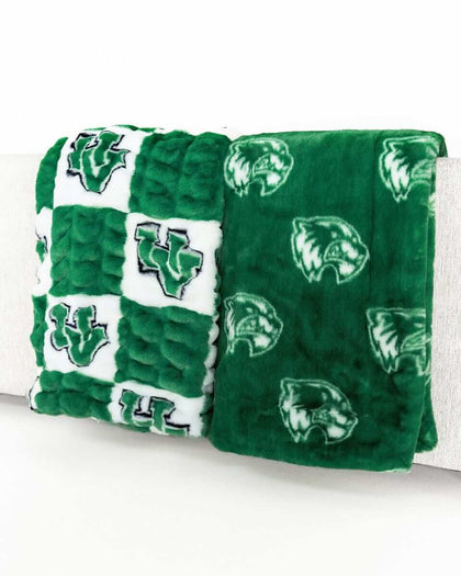 Green Utah Valley Wolverines blanket with checkered and logo patterns displayed on a bench.