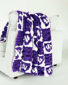 Purple and white checkered Weber State Wildcats blanket draped over light gray chair.